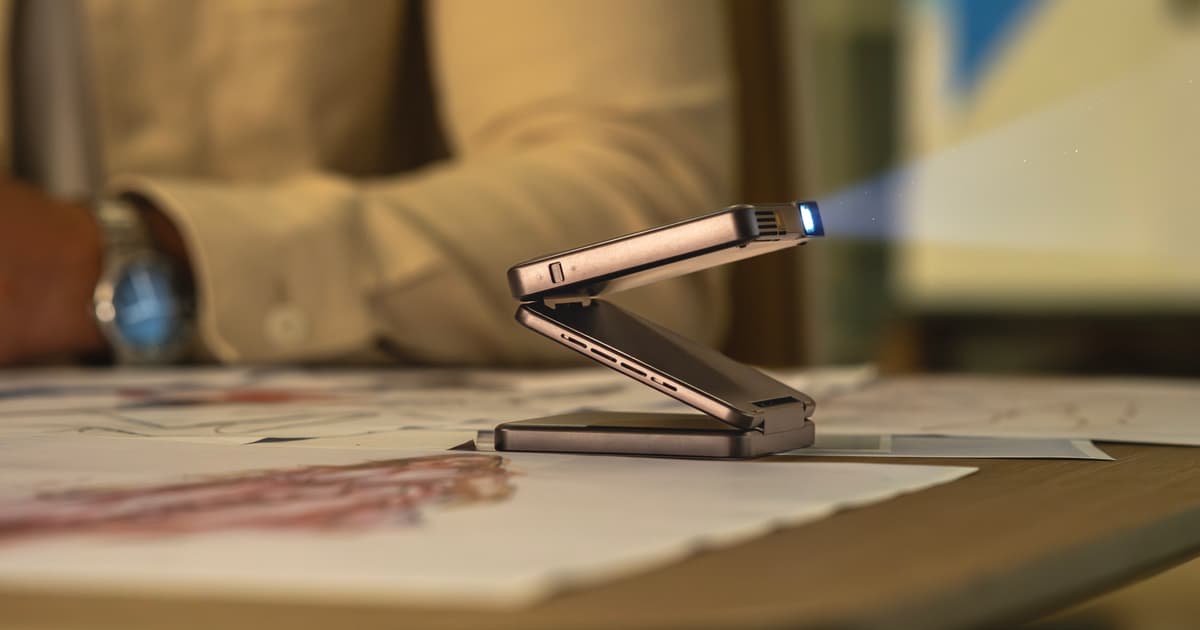 Portable mini projector stands on its own with tri-fold hinge [Video]